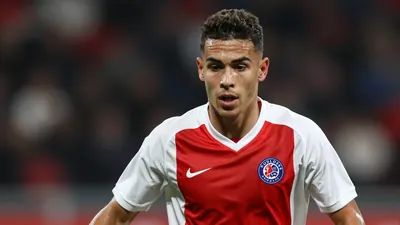 A photorealistic image of an anonymous young Danish midfielder in a Toulouse Football Club kit (red and white stripes...