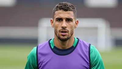 Mid-shot of a muscular 24-year-old Toulouse Football Club training player, head-and-shoulders, face sharp and expressive...