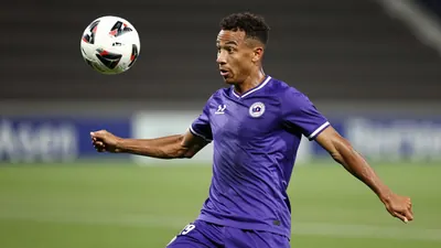 A 25-year-old Toulouse Football Club midfielder, with a muscular build, wearing a purple jersey, with a shallow depth of...