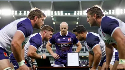 A tense Ligue 1 match-up on a rain-slicked pitch, anonymous Toulouse players in plain white shirts and black shorts...