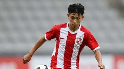 Photorealistic image of a young left winger, 18 years old, in a tight action crop, wearing a clean solid red and white...